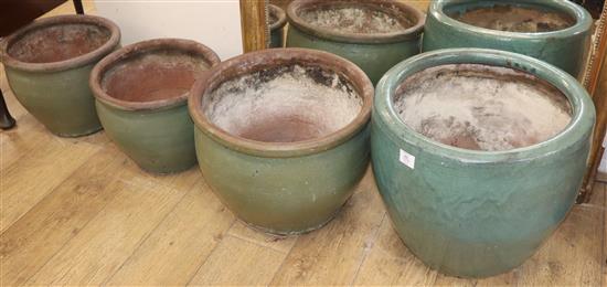 A set of four green glazed pottery planters W.50cm, 49cm, 39cm (2)